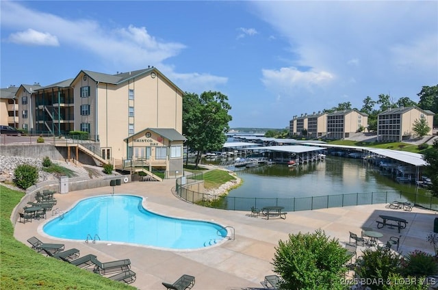 view of pool featuring a patio area and a water view