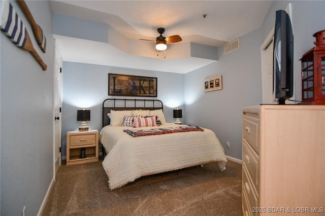 bedroom with ceiling fan and dark colored carpet