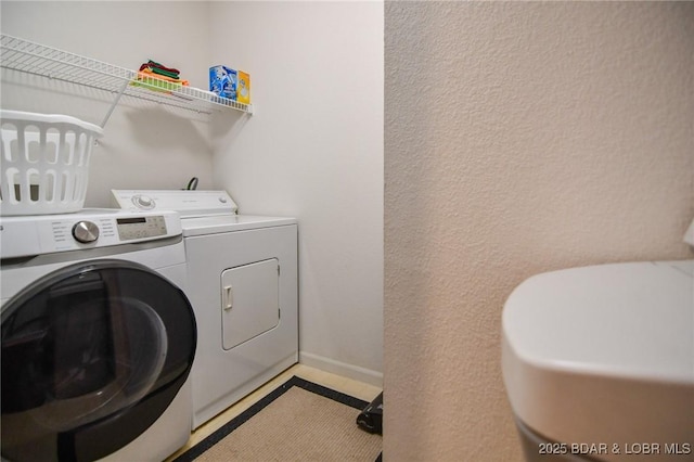 washroom with light tile patterned floors and separate washer and dryer