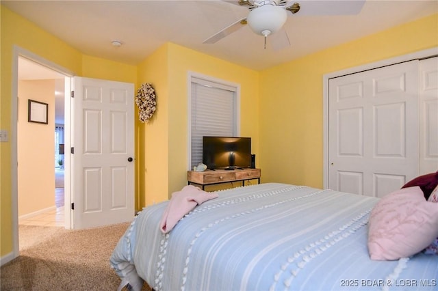 bedroom featuring carpet, ceiling fan, and a closet