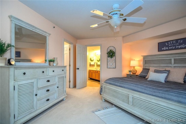 carpeted bedroom featuring ceiling fan and ensuite bathroom