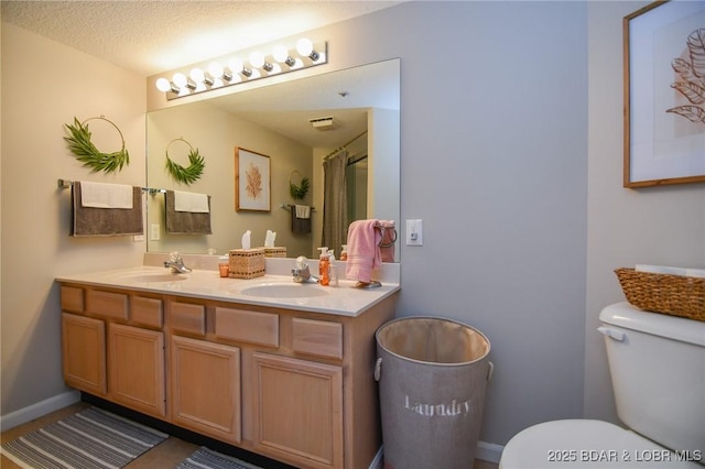 bathroom with a shower with shower curtain, vanity, toilet, and a textured ceiling