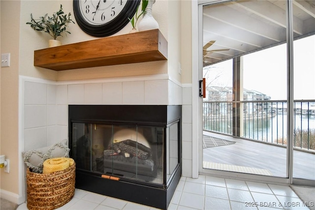 room details with ceiling fan and a fireplace