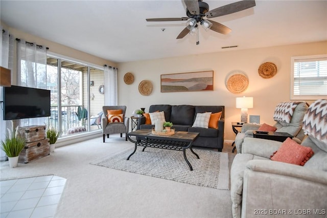 carpeted living room featuring plenty of natural light and ceiling fan