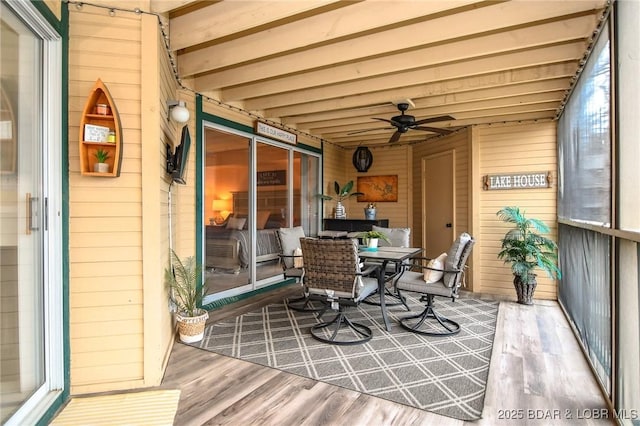 sunroom with beam ceiling and ceiling fan