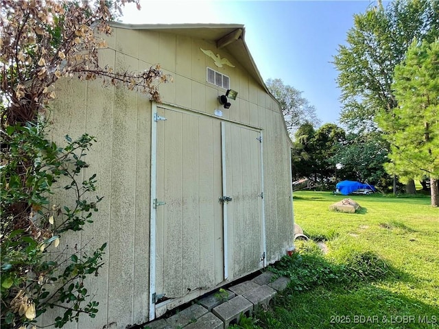 view of outdoor structure featuring a lawn