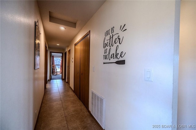 corridor featuring dark tile patterned flooring