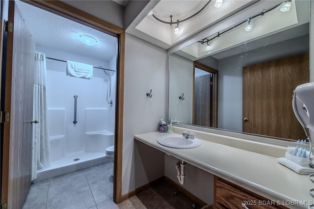 bathroom featuring sink, walk in shower, tile patterned flooring, a textured ceiling, and toilet