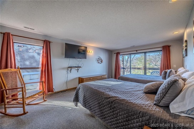 carpeted bedroom featuring a textured ceiling