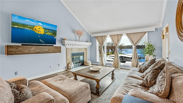 living room featuring hardwood / wood-style floors, crown molding, and vaulted ceiling