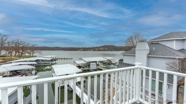 balcony with a dock and a water view