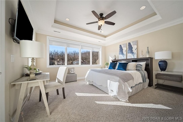 bedroom with crown molding, a raised ceiling, baseboards, carpet floors, and recessed lighting