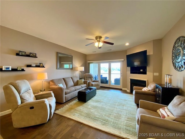 living room with wood-type flooring and ceiling fan