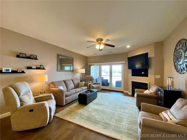 living room with wood-type flooring and ceiling fan
