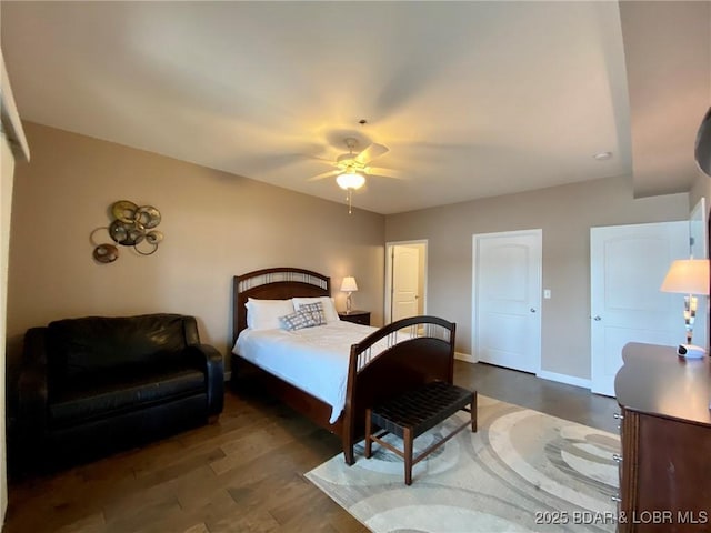 bedroom with dark hardwood / wood-style floors and ceiling fan