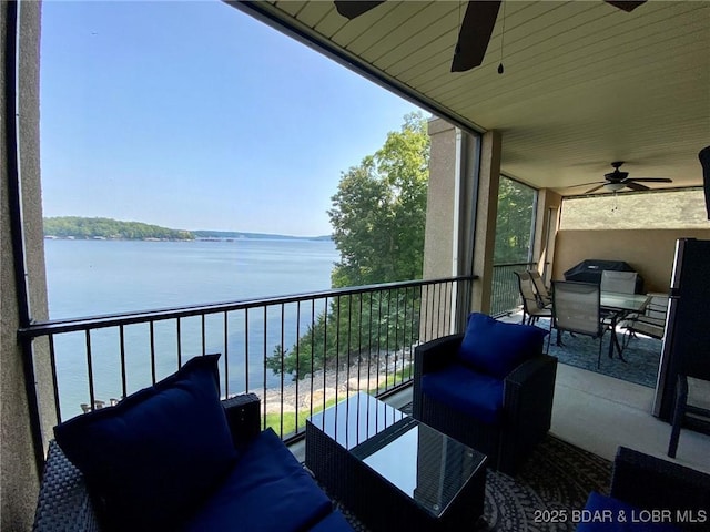 balcony featuring a water view and ceiling fan