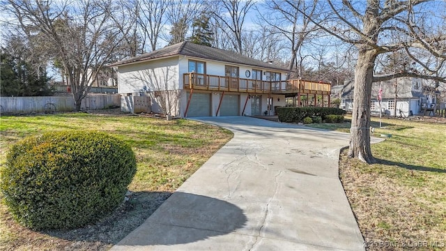 view of front of house featuring a front yard, a garage, and a deck