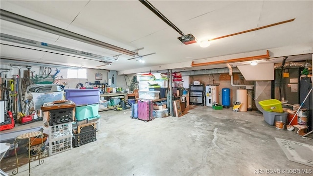 garage featuring a garage door opener, a workshop area, and electric water heater