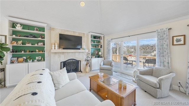 carpeted living room featuring a high end fireplace