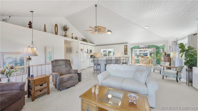 living room featuring high vaulted ceiling, light carpet, and ceiling fan