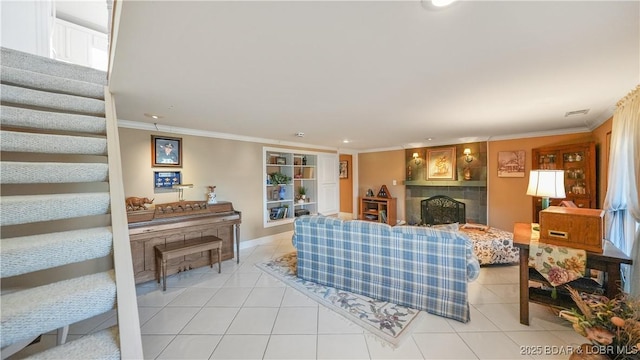 living room featuring ornamental molding, a fireplace, and light tile patterned floors