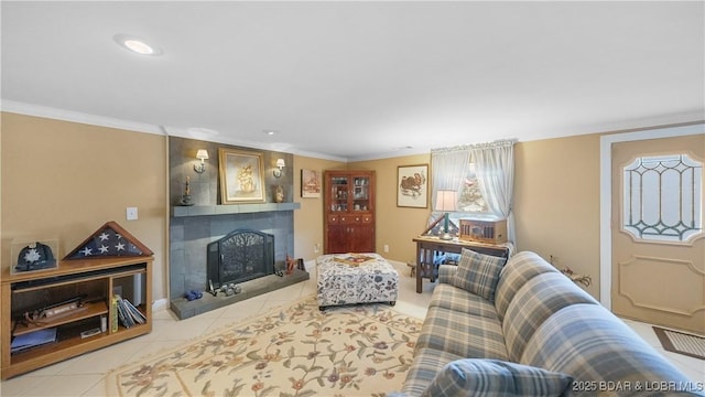 living room featuring a large fireplace and light tile patterned flooring