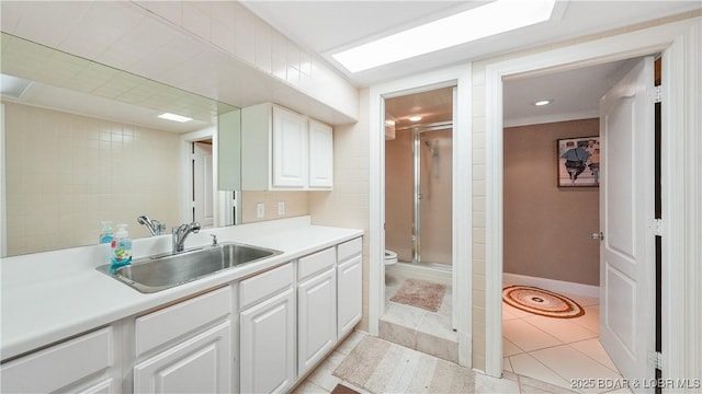 kitchen featuring sink, white cabinets, and light tile patterned floors