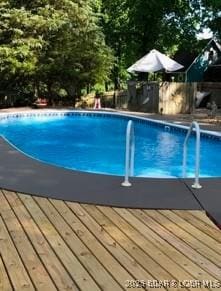 view of swimming pool with a wooden deck