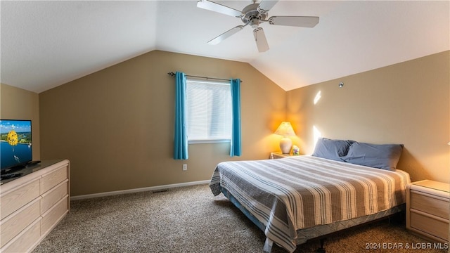 bedroom featuring ceiling fan, dark carpet, and vaulted ceiling