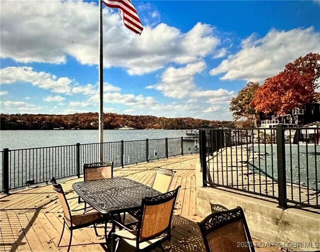 view of patio with a deck with water view