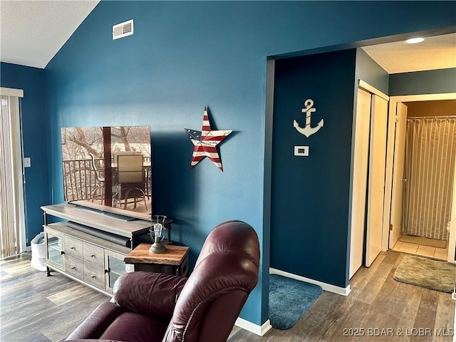 interior space with vaulted ceiling and hardwood / wood-style flooring