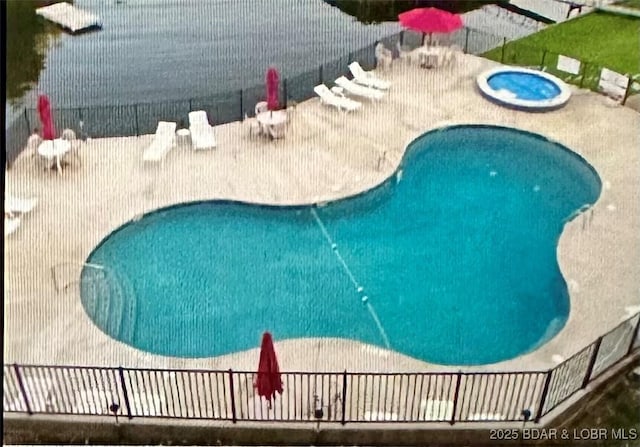 view of pool featuring an in ground hot tub and a patio area