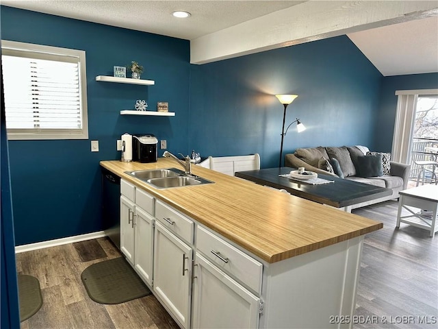 kitchen with sink, a textured ceiling, dark hardwood / wood-style flooring, black dishwasher, and white cabinets