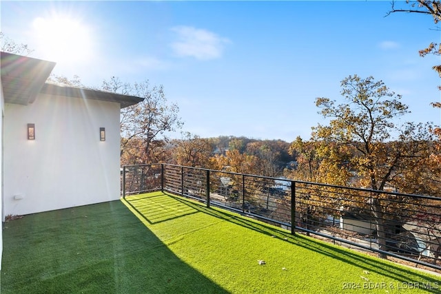 view of yard with a balcony