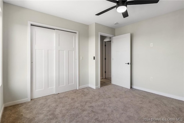 unfurnished bedroom featuring carpet, ceiling fan, and a closet