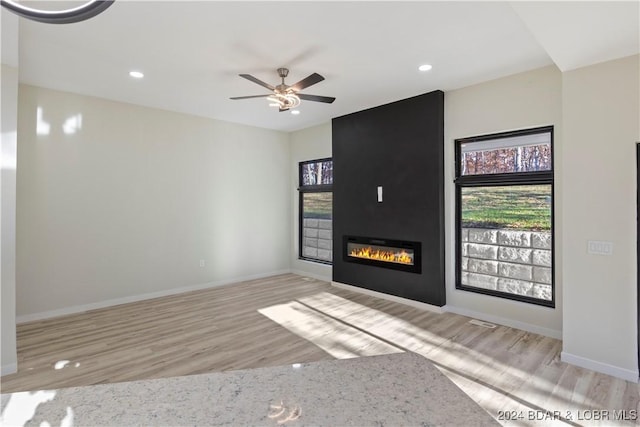 unfurnished living room featuring light hardwood / wood-style floors and ceiling fan