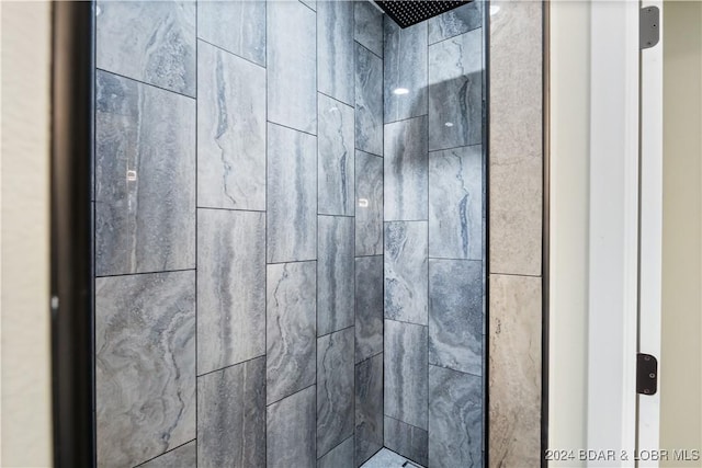 interior details featuring a tile shower