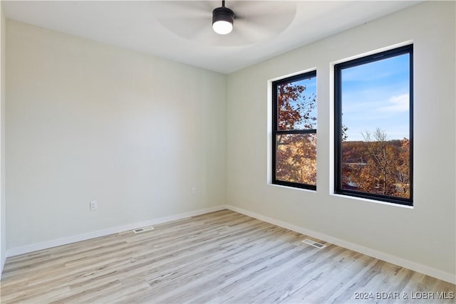 empty room with light wood-type flooring and ceiling fan