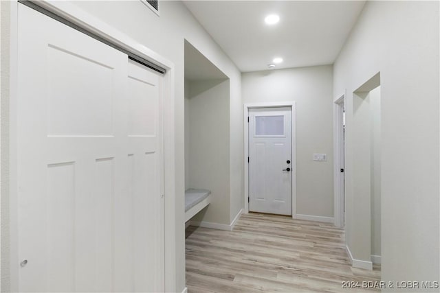 corridor with light hardwood / wood-style flooring