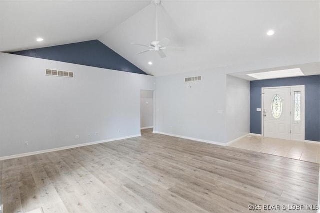 foyer with light wood-type flooring, ceiling fan, and lofted ceiling