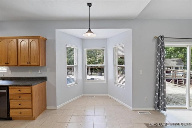 kitchen featuring dishwasher, light tile patterned floors, and pendant lighting