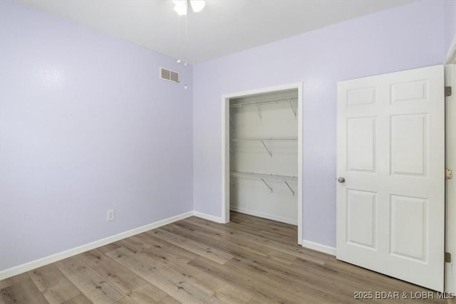 unfurnished bedroom featuring light hardwood / wood-style flooring and a closet