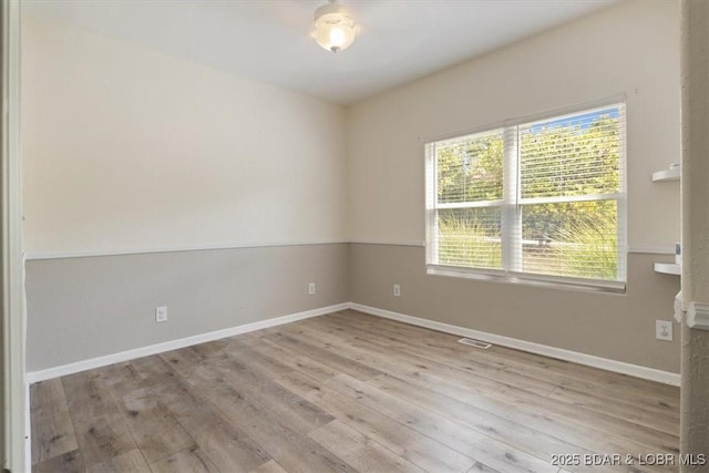 spare room featuring light hardwood / wood-style flooring