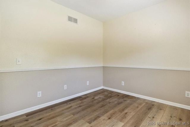 unfurnished room with hardwood / wood-style flooring