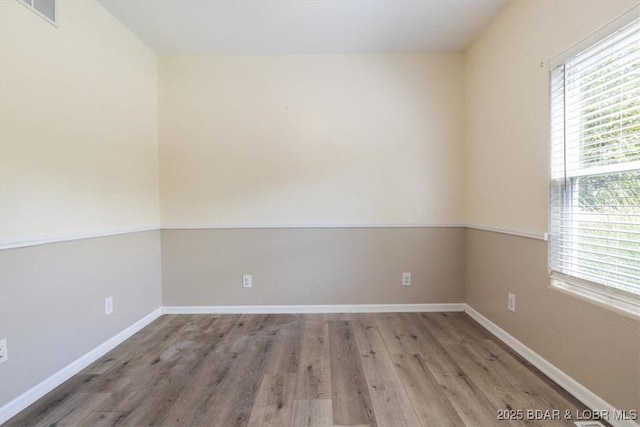 empty room with wood-type flooring