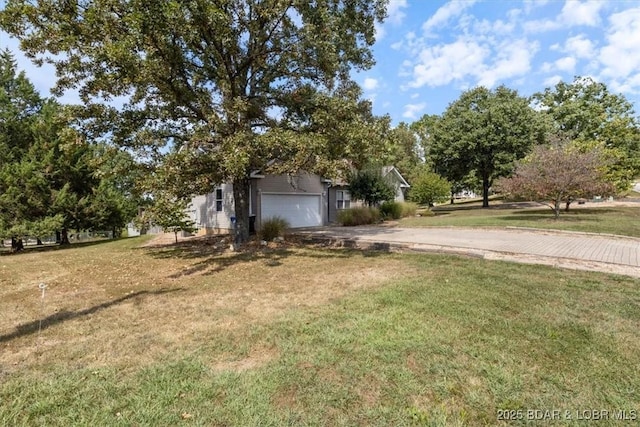 view of front of home with a garage and a front yard