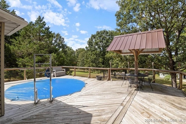 view of swimming pool with a wooden deck