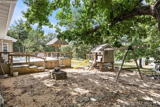 view of yard with a deck and a playground