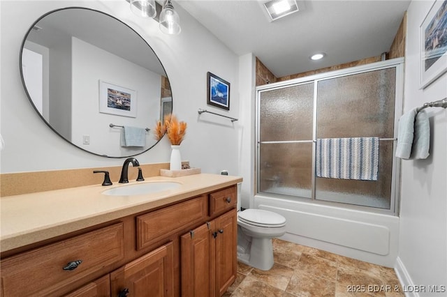 full bathroom featuring shower / bath combination with glass door, vanity, and toilet