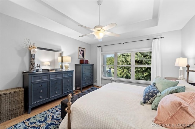 bedroom with ceiling fan and light hardwood / wood-style floors